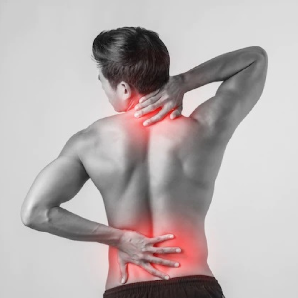 Image of a man rubbing his sore back and neck due to delayed onset muscle soreness or DOMS.